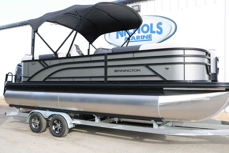 The Image of Bennington 22 S1SSR Tri Toon 2027 on a trailer with a black sunshade. - 0