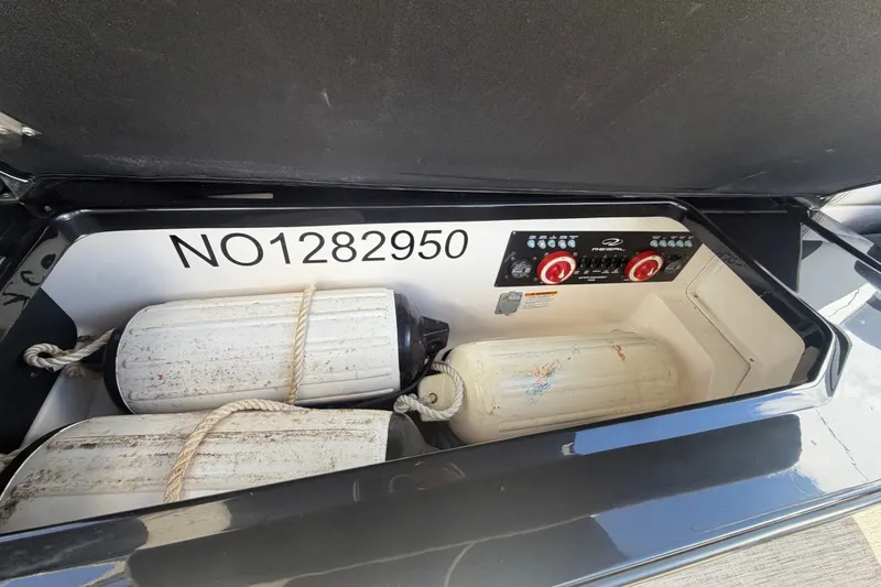 Slide: The Image of Storage compartment of 2017 Regal 29 OBX boat with fenders and control panel. - 25