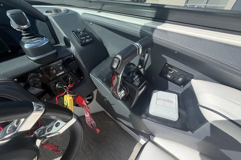 Slide: The Image of 2017 Regal 29 OBX boat cockpit with steering wheel, controls, and dashboard details. - 16