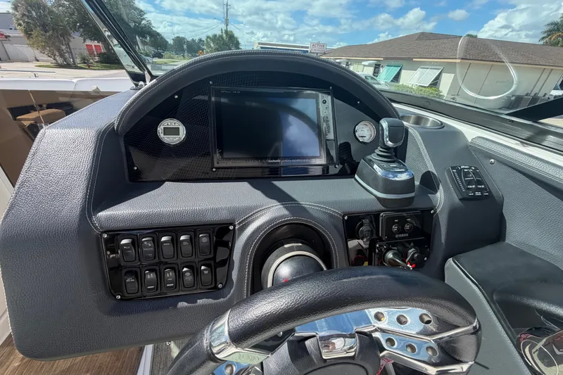 Slide: The Image of Dashboard of a 2017 Regal 29 OBX boat with steering wheel and controls. - 15