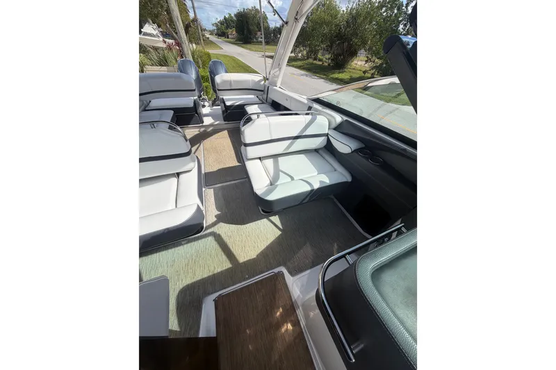 Slide: The Image of Interior of 2017 Regal 29 OBX boat with white seating and open layout. - 19