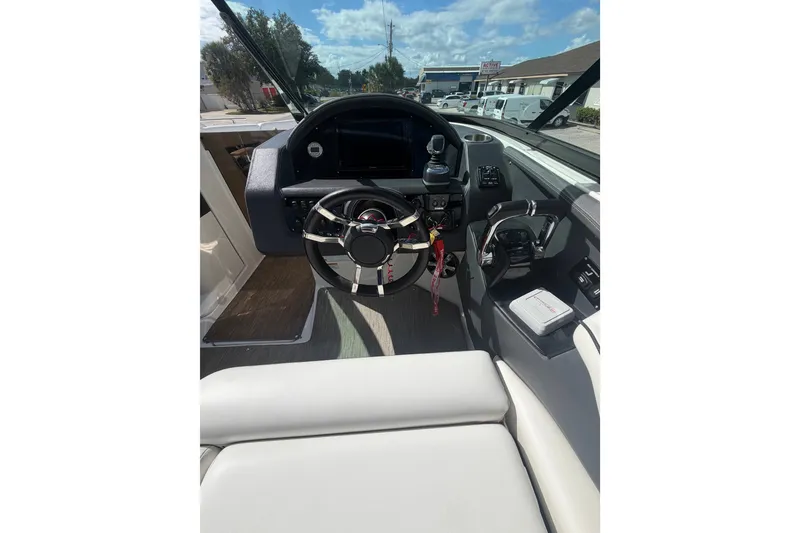 Slide: The Image of 2017 Regal 29 OBX boat cockpit with steering wheel and control panel. - 14