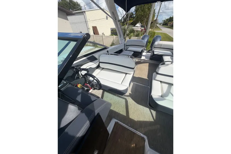 Slide: The Image of 2017 Regal 29 OBX boat interior with white seating and steering wheel. - 18