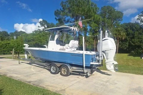 Slide: The Image of 2022 Sportsman Masters 247OE Bay Boat on trailer, parked outdoors under clear sky. - 3