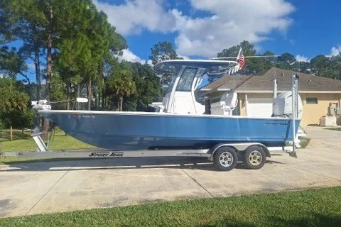 The Image of 2022 Sportsman Masters 247OE Bay Boat on trailer in residential driveway. - 0