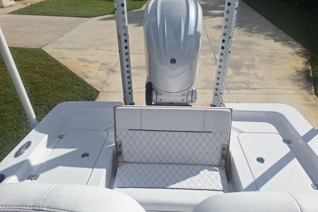 Slide: The Image of 2022 Sportsman Masters 247OE Bay Boat with sleek white seating and powerful engine. - 4