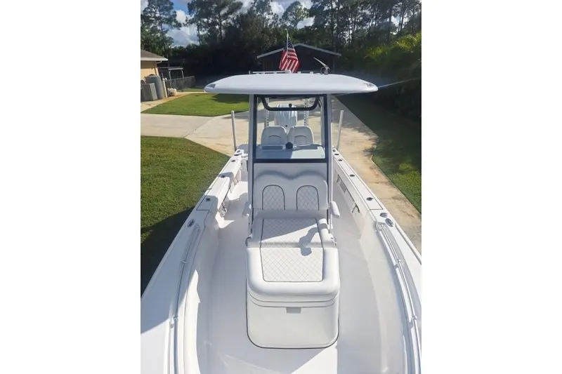 Slide: The Image of 2022 Sportsman Masters 247OE Bay Boat with T-top and seating, parked outdoors. - 10