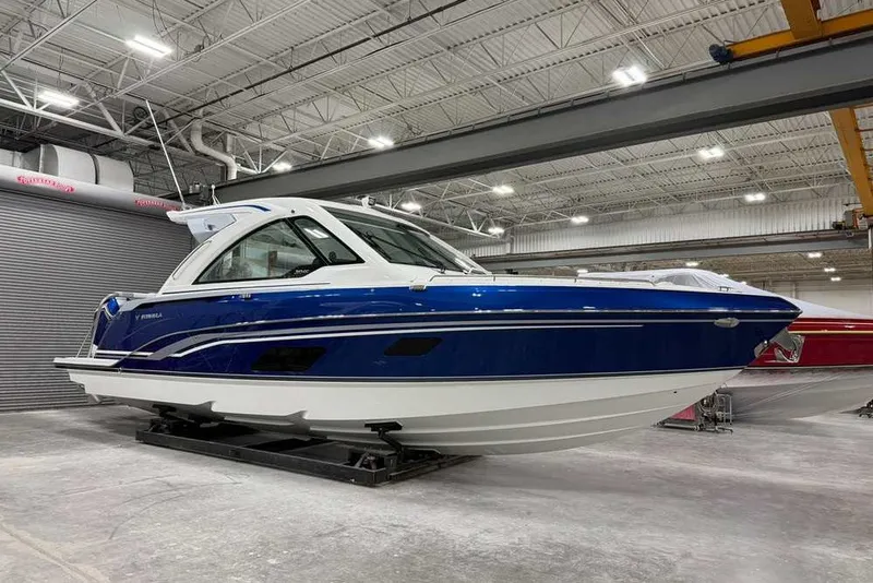 Slide: The Image of 2027 Formula 360 Super Sport Crossover boat in a spacious indoor facility. - 9