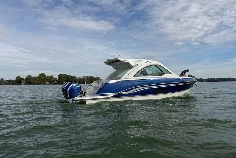 Slide: The Image of 2027 Formula 360 Super Sport Crossover boat on water, blue and white design. - 2