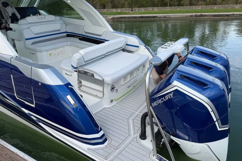 Slide: The Image of 2027 Formula 360 Super Sport Crossover boat with triple Mercury engines docked on calm water. - 4