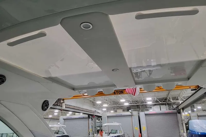 Slide: The Image of 2027 Formula 360 Super Sport Crossover boat interior ceiling in a workshop setting. - 26