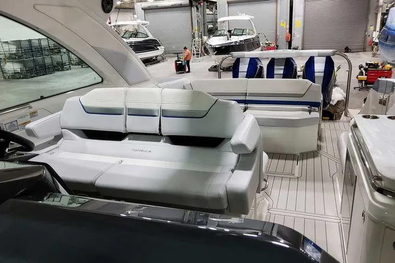 Slide: The Image of Interior of 2027 Formula 360 Super Sport Crossover boat with luxurious seating in a showroom. - 23