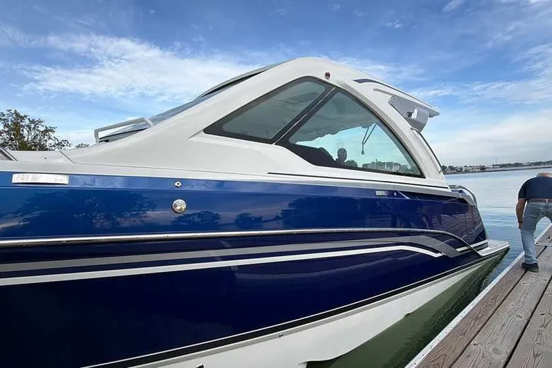 Slide: The Image of 2027 Formula 360 Super Sport Crossover boat docked on a sunny day. - 7