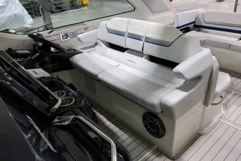 Slide: The Image of Interior of 2027 Formula 360 Super Sport Crossover boat with white seating and modern controls. - 24