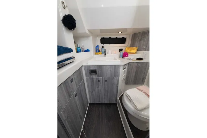 Slide: The Image of Modern bathroom interior of 2027 Formula 360 Super Sport Crossover boat, featuring sleek cabinetry and amenities. - 48