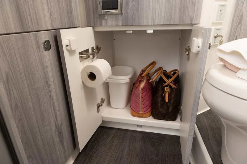 Slide: The Image of Cabinet storage in 2027 Formula 360 Super Sport Crossover bathroom with bags and toilet paper. - 49