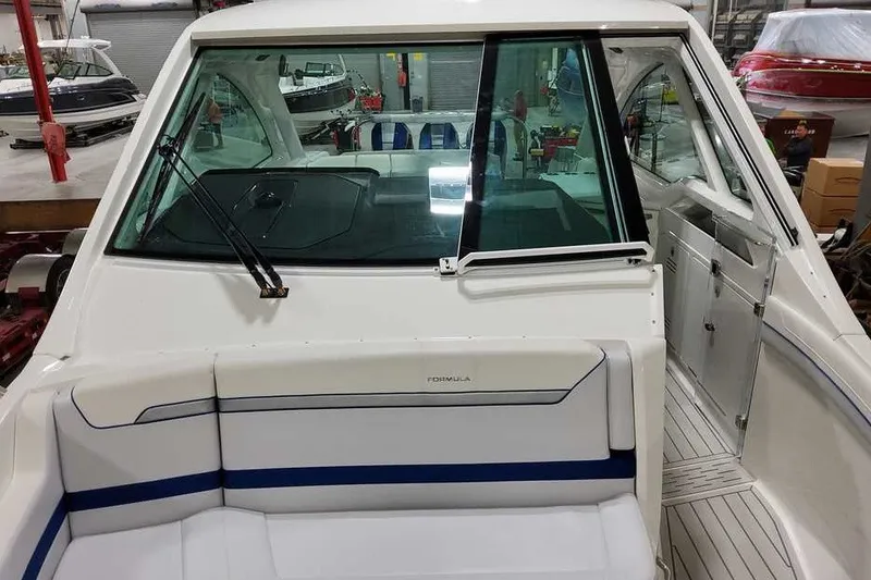 Slide: The Image of 2027 Formula 360 Super Sport Crossover boat interior with seating and windshield view. - 28