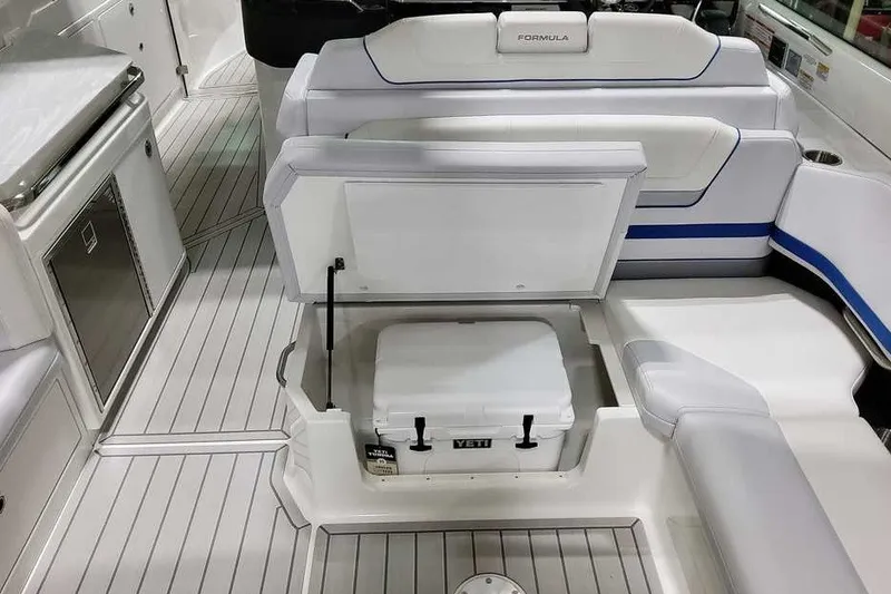 Slide: The Image of 2027 Formula 360 Super Sport Crossover boat interior with seating and Yeti cooler. - 22