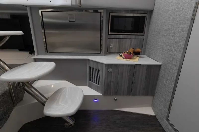 Slide: The Image of Modern interior of 2027 Formula 360 Super Sport Crossover with kitchenette and sleek design. - 39