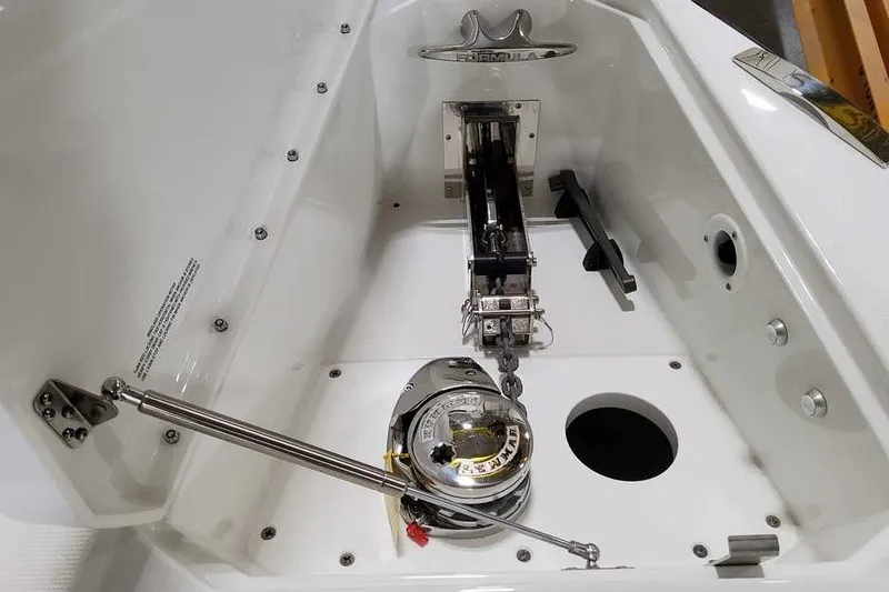 Slide: The Image of Anchor compartment of 2027 Formula 360 Super Sport Crossover boat, featuring winch and chain mechanism. - 32
