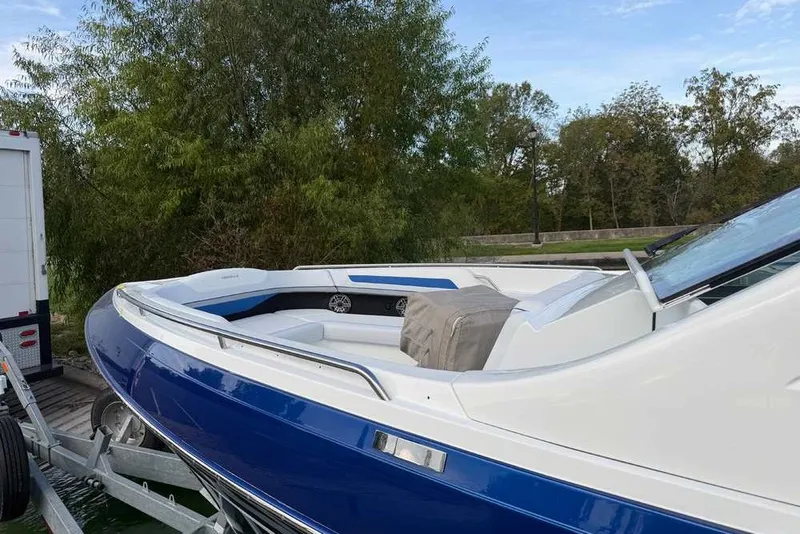 Slide: The Image of 2027 Formula 360 Super Sport Crossover boat on trailer, surrounded by trees. - 8