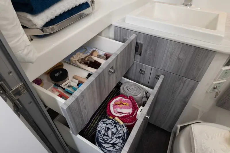 Slide: The Image of Modern bathroom storage in 2027 Formula 360 Super Sport Crossover, featuring organized drawers with toiletries. - 50