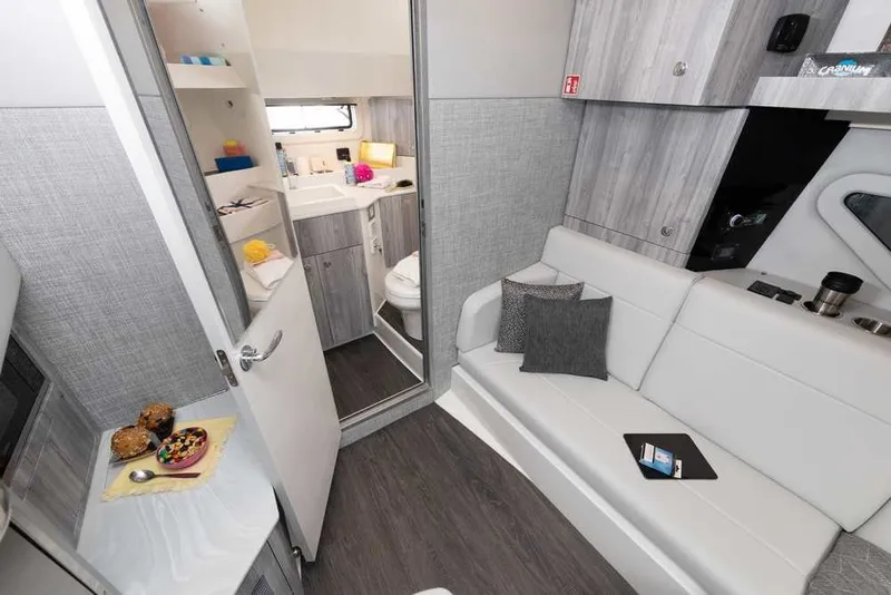 Slide: The Image of Interior of 2027 Formula 360 Super Sport Crossover, featuring modern seating and compact bathroom. - 44
