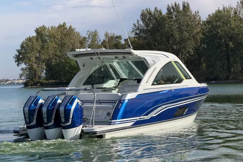 Slide: The Image of 2027 Formula 360 Super Sport Crossover boat with triple engines on a serene lake. - 1