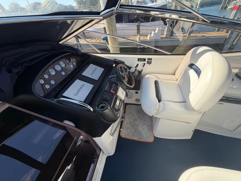 Slide: The Image of The cockpit of a 2006 Sunseeker Portofino 46 with white seats and Garmin devices. - 10