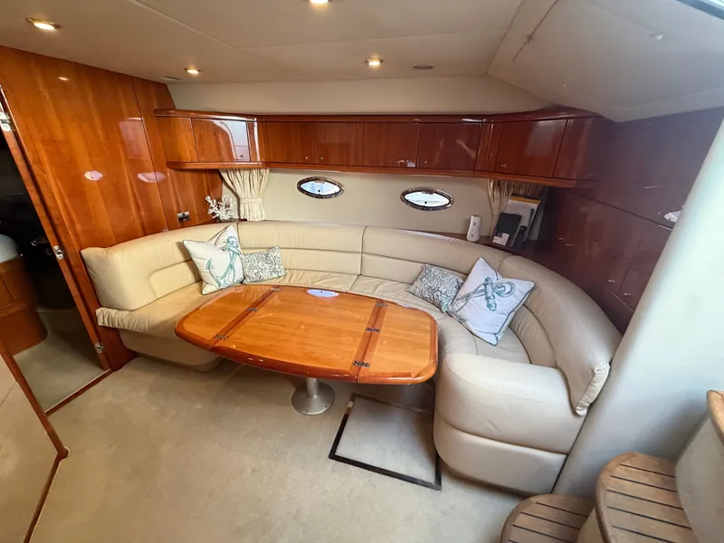 Slide: The Image of Interior of Sunseeker Portofino 46 with elegant leather seating and wooden table. - 16