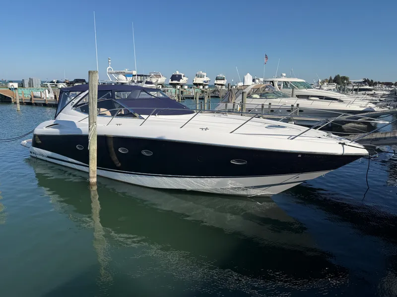 Slide: The Image of A 2006 Sunseeker Portofino 46 docked in the water, surrounded by other boats. - 1