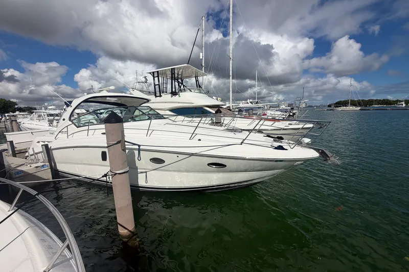 Slide: The Image of 2010 Sea Ray 390 Sundancer yacht docked at marina under cloudy sky. - 1