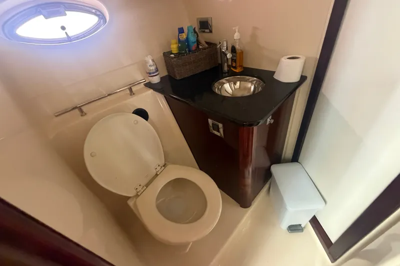 Slide: The Image of Bathroom interior of 2010 Sea Ray 390 Sundancer yacht, featuring toilet and sink. - 18