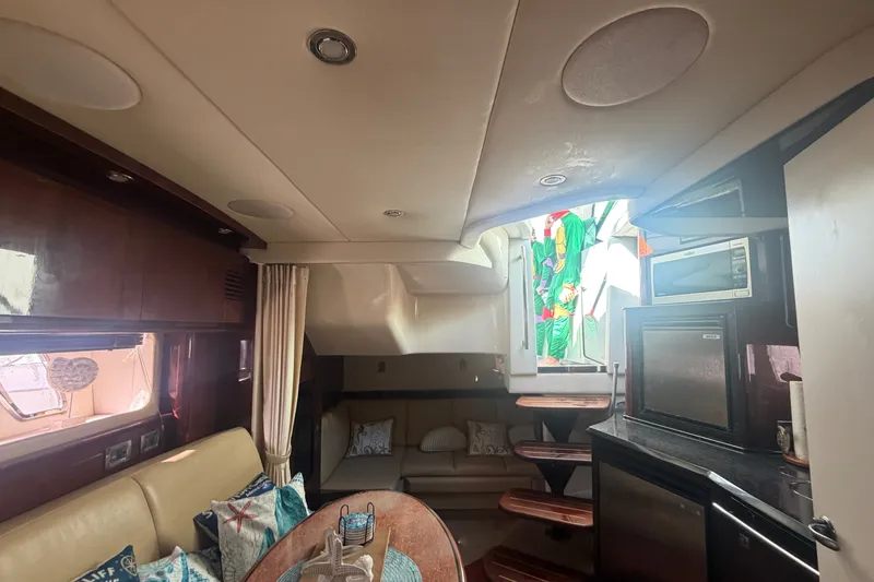 Slide: The Image of Interior of 2010 Sea Ray 390 Sundancer yacht with cozy seating and modern amenities. - 10