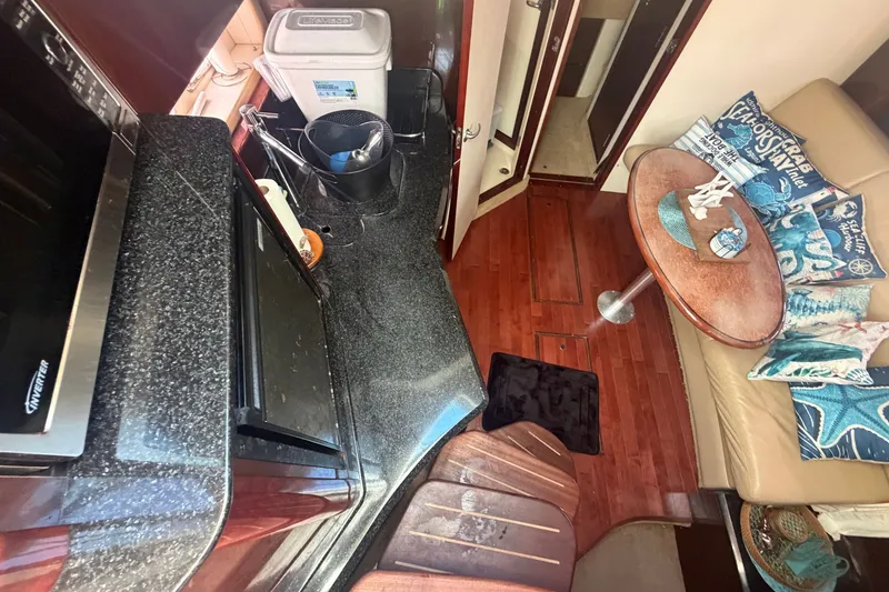 Slide: The Image of Interior of 2010 Sea Ray 390 Sundancer yacht with kitchenette and seating area. - 6