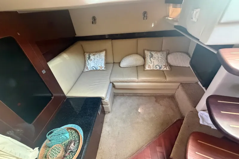 Slide: The Image of Interior of 2010 Sea Ray 390 Sundancer with beige seating and decorative pillows. - 14