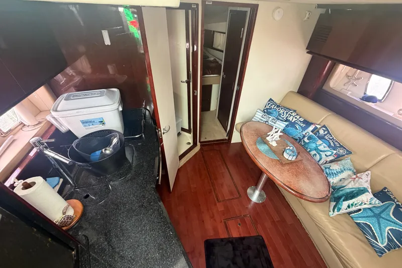 Slide: The Image of Interior of 2010 Sea Ray 390 Sundancer with kitchenette and cozy seating area. - 7