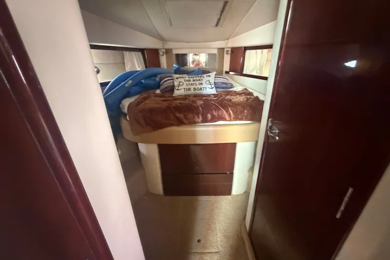 Slide: The Image of Cozy cabin interior of 2010 Sea Ray 390 Sundancer with plush bedding and decorative pillows. - 12