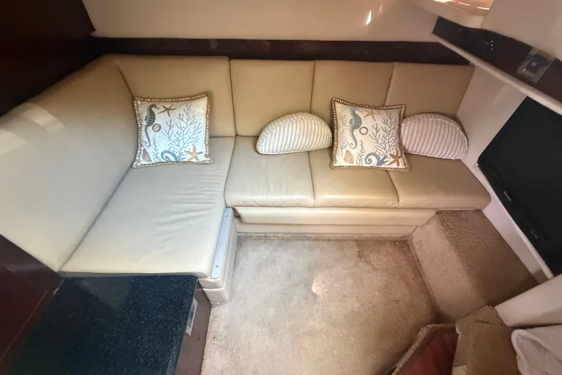 Slide: The Image of Interior of 2010 Sea Ray 390 Sundancer with beige leather seating and decorative pillows. - 15