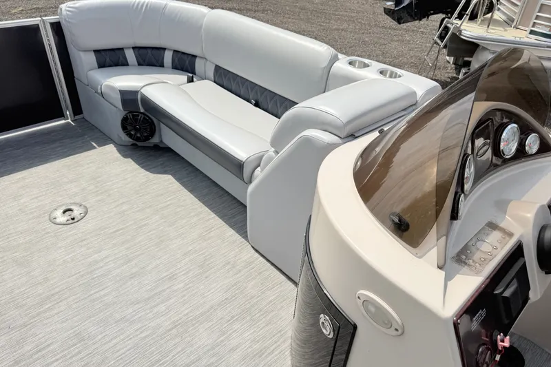 Slide: The Image of 2013 Sylvan Mirage 820 Cruise boat interior with plush seating and control panel. - 9