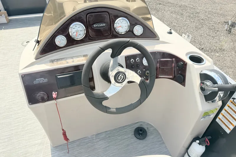 Slide: The Image of Steering console of 2013 Sylvan Mirage 820 Cruise boat with gauges and controls. - 3