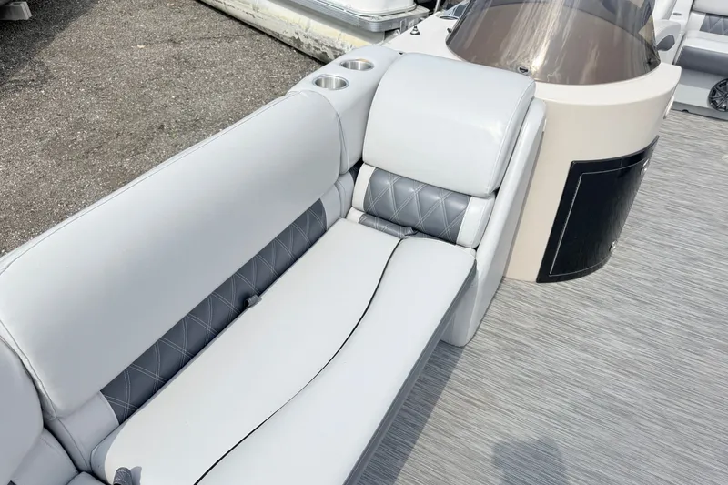 Slide: The Image of 2013 Sylvan Mirage 820 Cruise boat interior with gray seating and cup holders. - 5