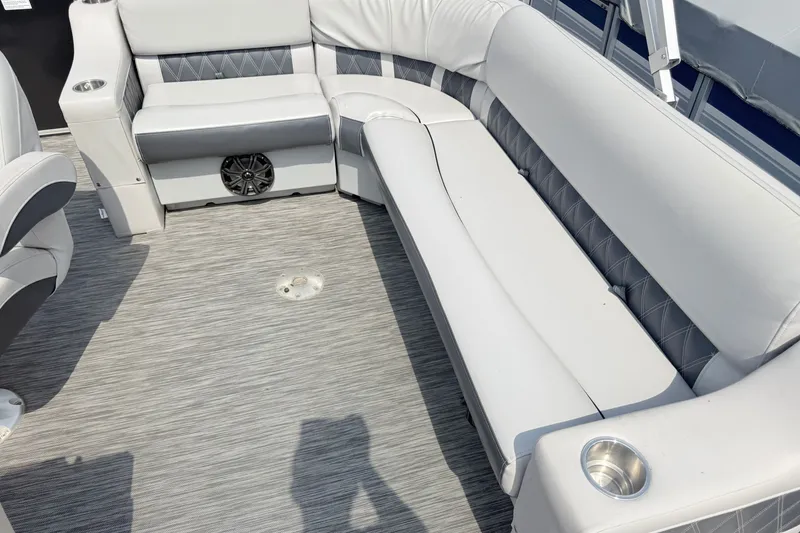 Slide: The Image of 2013 Sylvan Mirage 820 Cruise boat interior with gray seating and cup holders. - 8