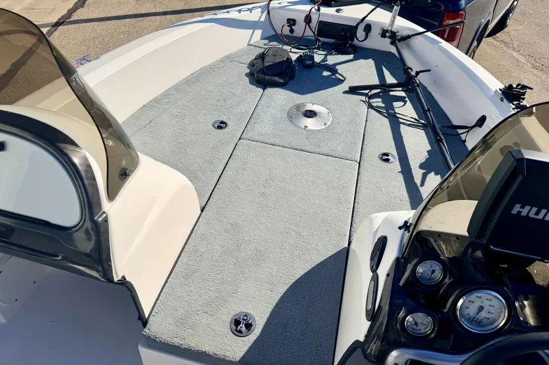 Slide: The Image of 2007 Stratos 375 XF boat interior with carpeted deck and fishing equipment. - 77