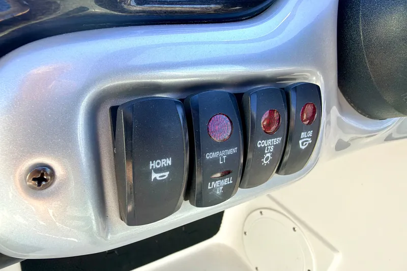 Slide: The Image of Control panel switches on a 2007 Stratos 375 XF boat dashboard. - 44