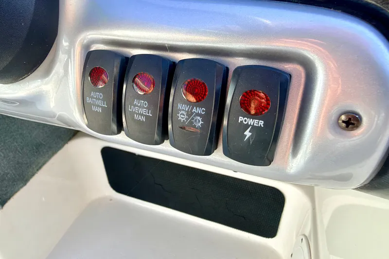 Slide: The Image of Control panel switches on a 2007 Stratos 375 XF boat dashboard. - 43