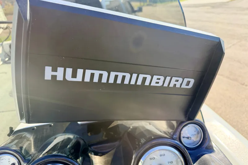 Slide: The Image of Humminbird device on 2007 Stratos 375 XF dashboard with gauges visible. - 45