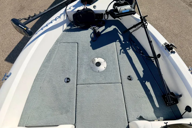 Slide: The Image of 2007 Stratos 375 XF boat deck with fishing equipment and carpeted surface. - 59