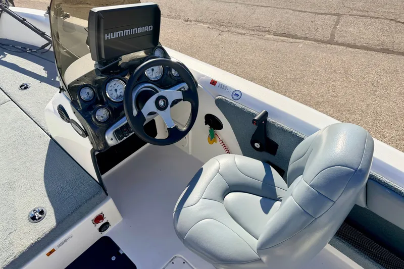 Slide: The Image of Steering console of 2007 Stratos 375 XF boat with Humminbird display and cushioned seat. - 36