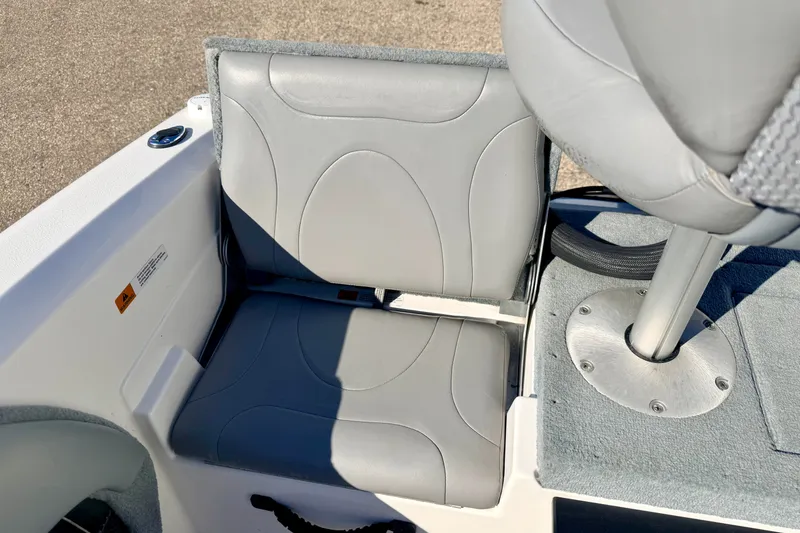 Slide: The Image of Gray seating area on a 2007 Stratos 375 XF boat, featuring cushioned seats and a pedestal base. - 26